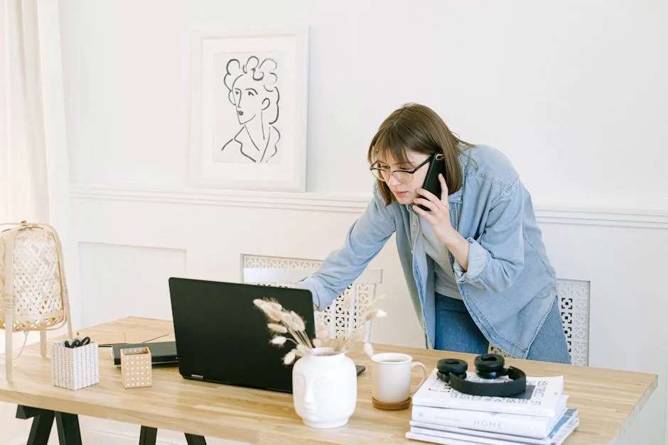 A practice staff member taking a phone call at a desk in an accountancy office